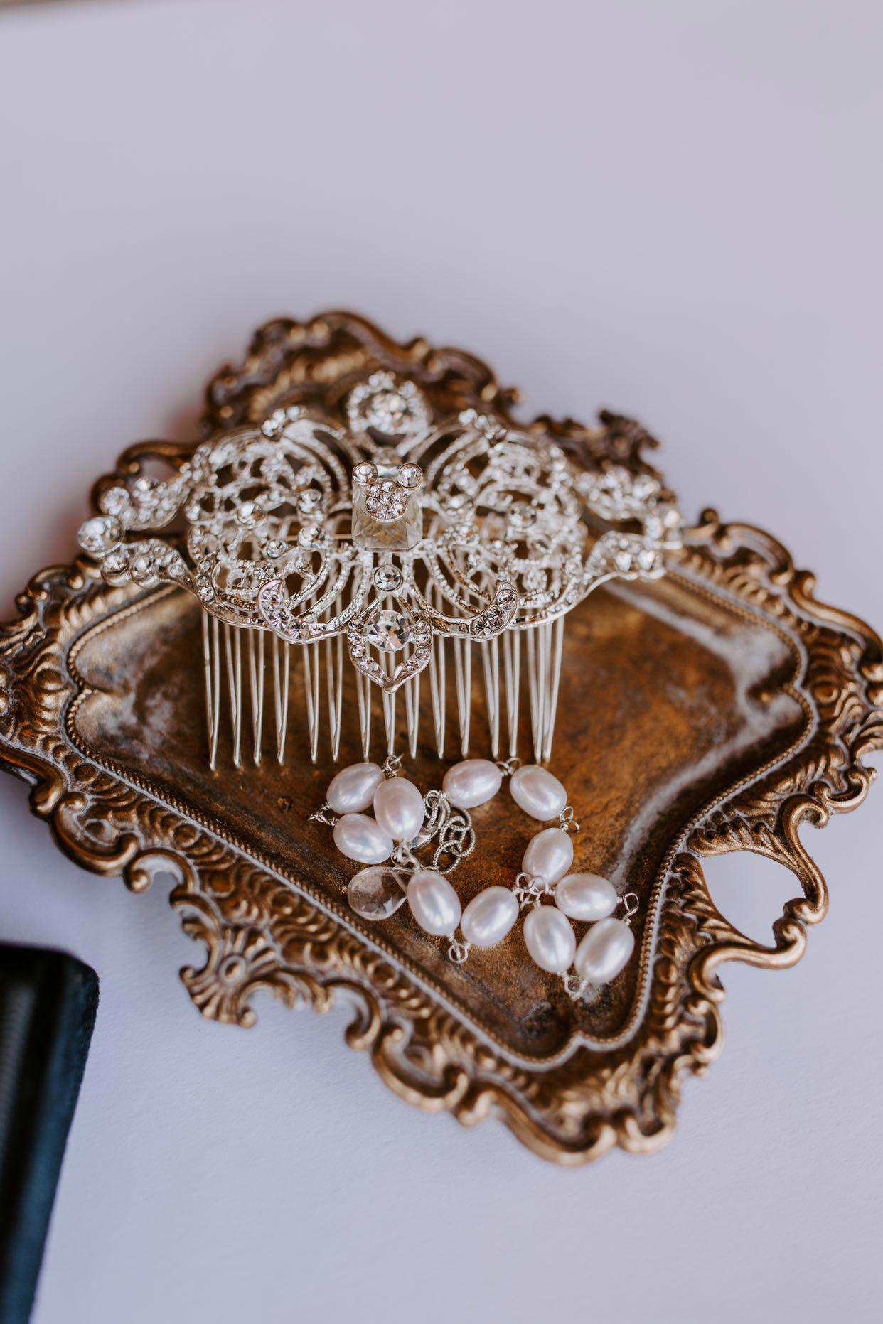 Handcrafted pearl bridal bracelet shown with antique hair comb