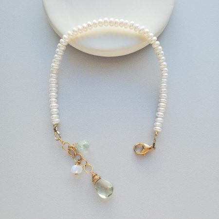 Pearl and gem dangle bracelet in gold